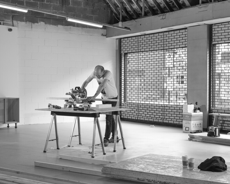 a person using a woodworking saw in a room