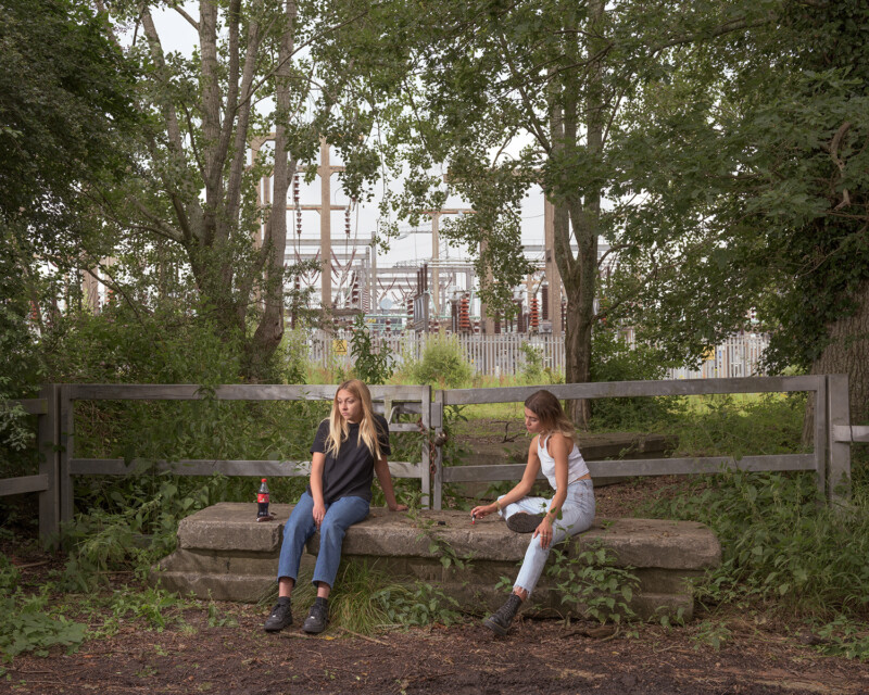 two women sitting on a bench