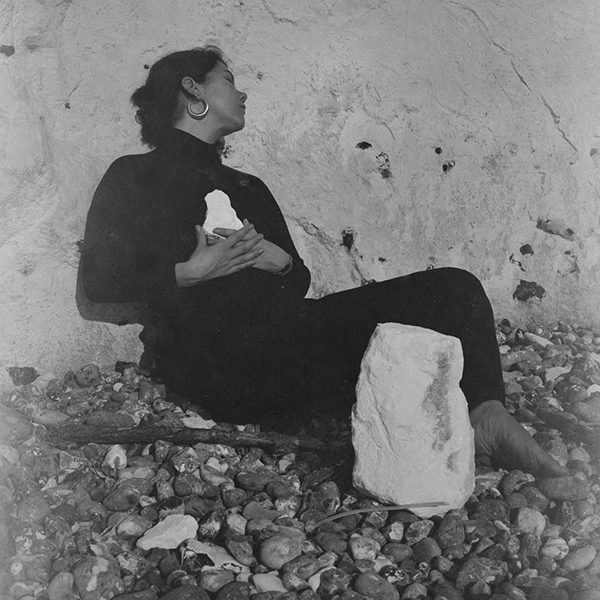 woman sitting on a pebble beach