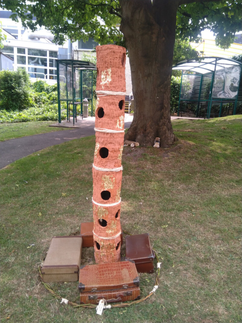 terracotta tower surrounded by vintage suitcases