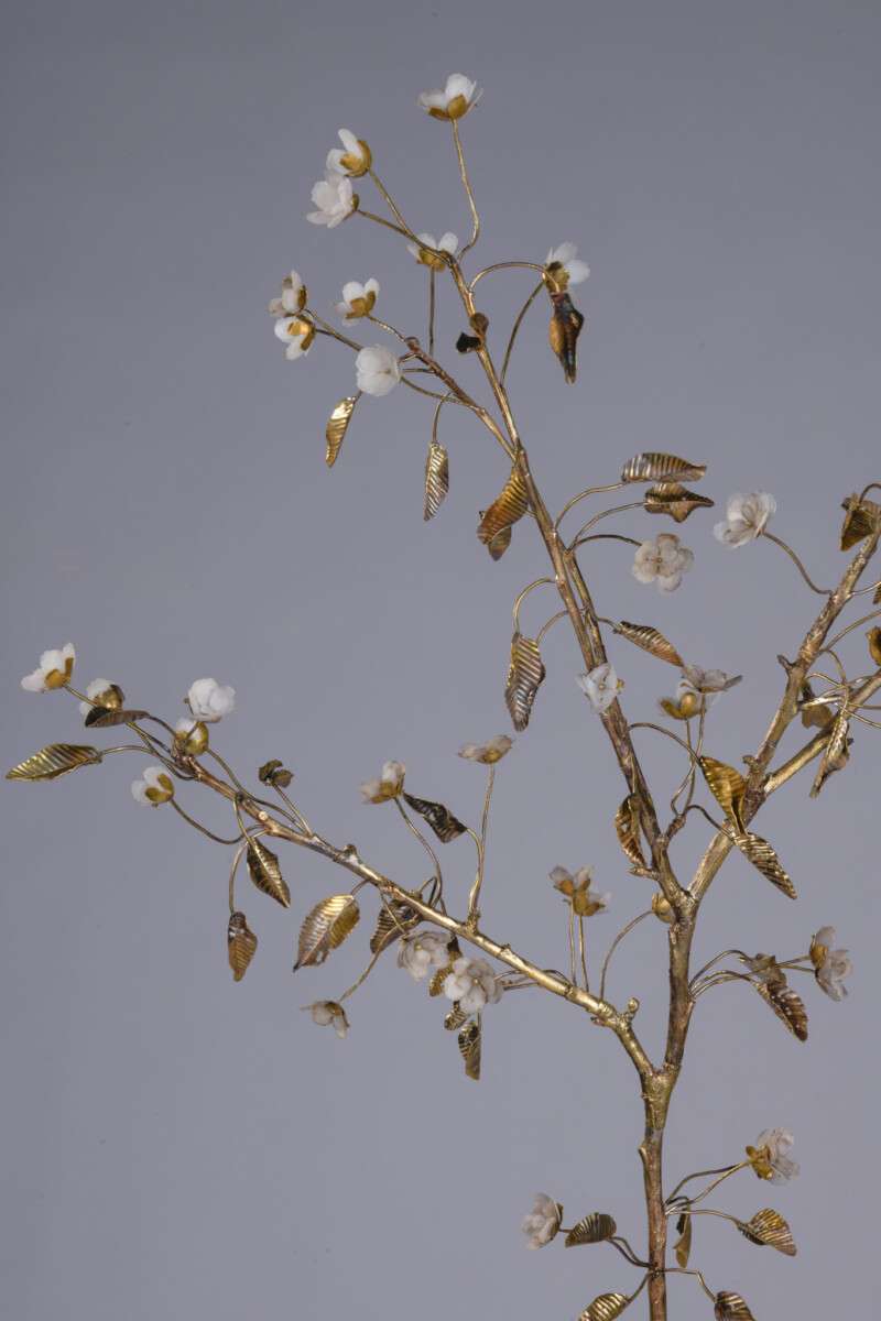 artwork of cast metal branch with delicate flowers