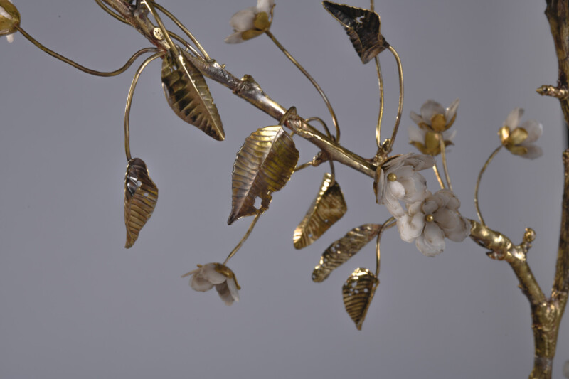 close up of delicate cast metal twigs with flowers